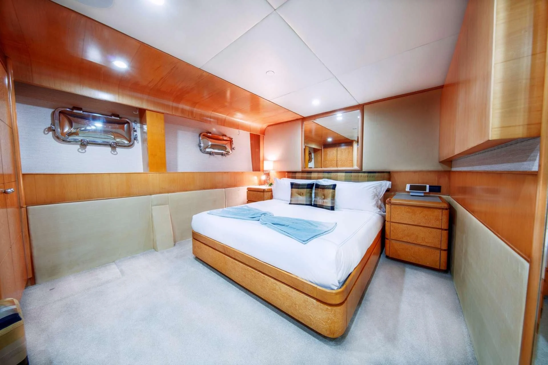 a bedroom with a bed and a dresser aboard ISLAND HEIRESS Yacht for Charter