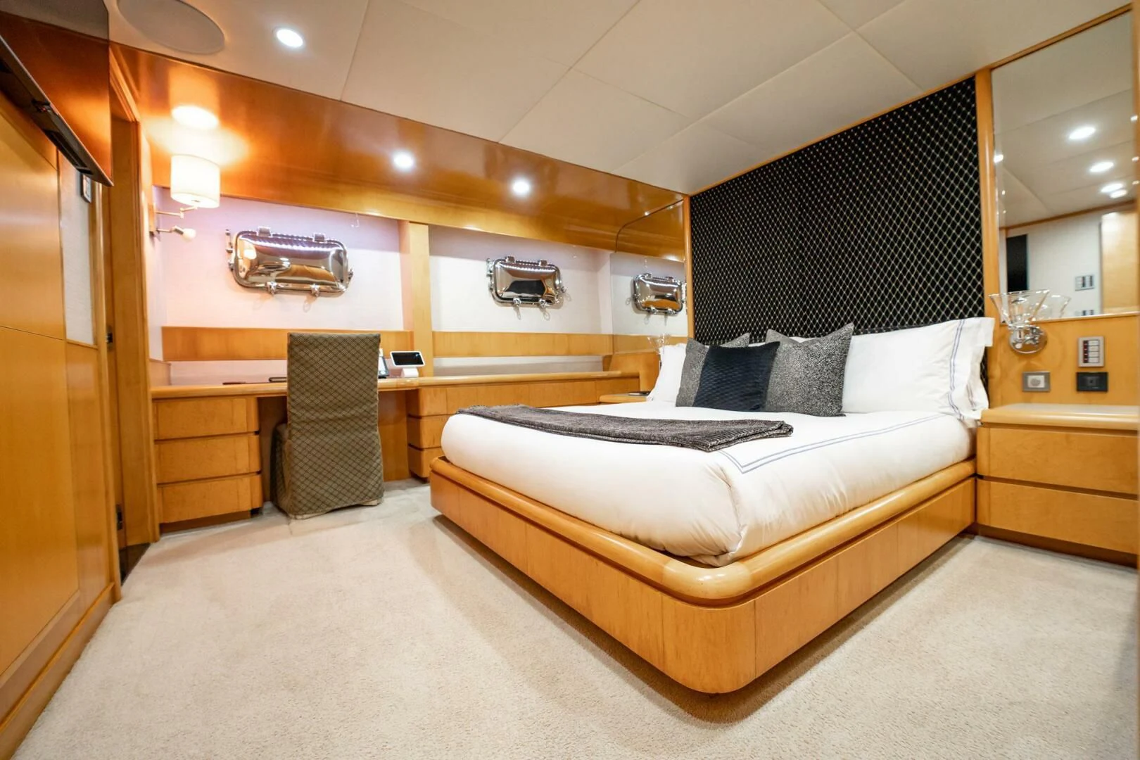 a bedroom with a bed and a chair aboard ISLAND HEIRESS Yacht for Charter