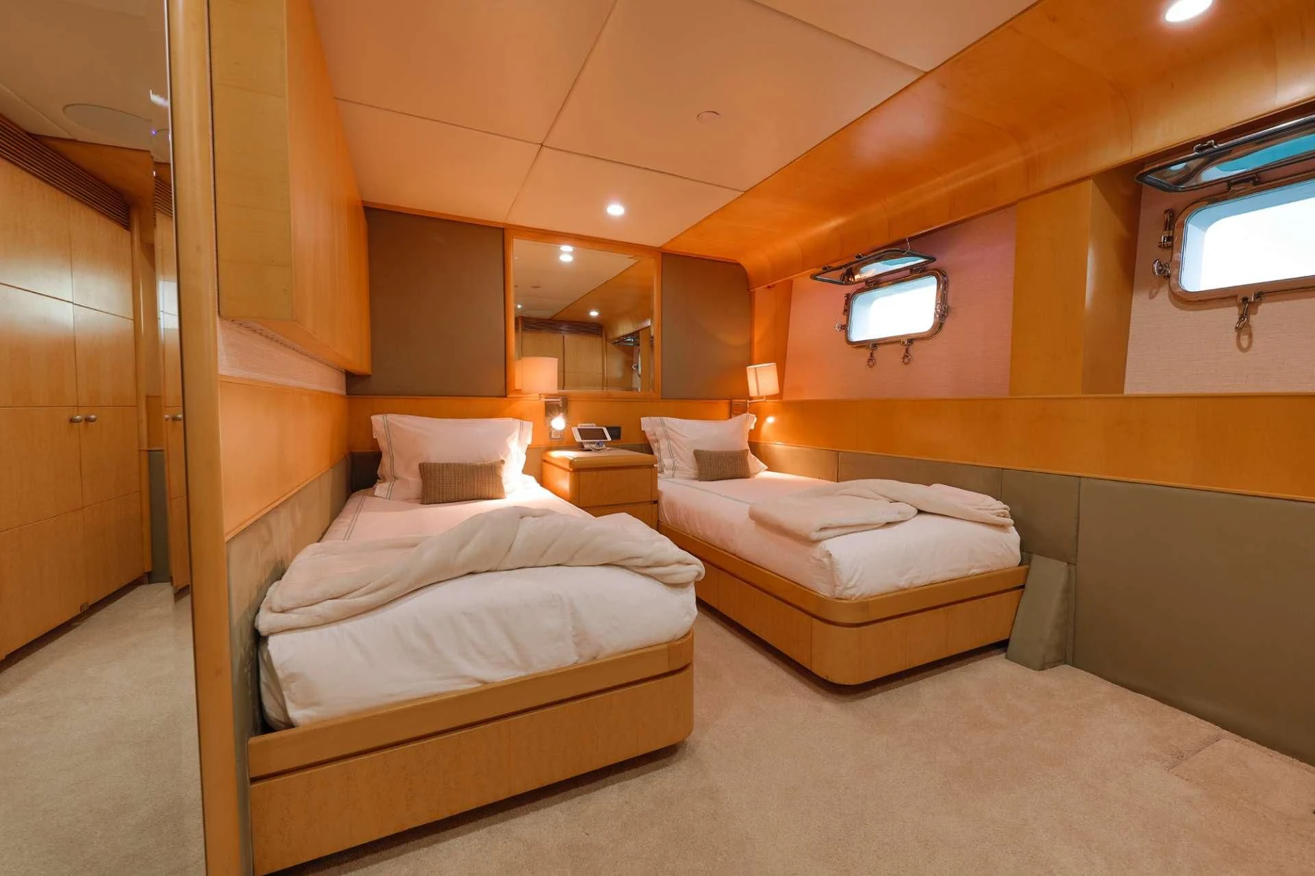 a room with beds and a mirror aboard ISLAND HEIRESS Yacht for Charter