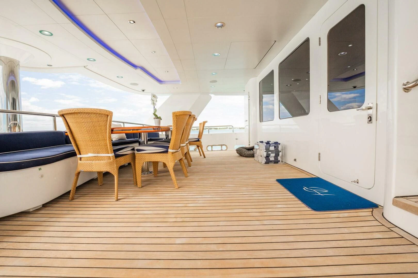 a room with a wood floor and chairs and a blue rug aboard ISLAND HEIRESS Yacht for Charter