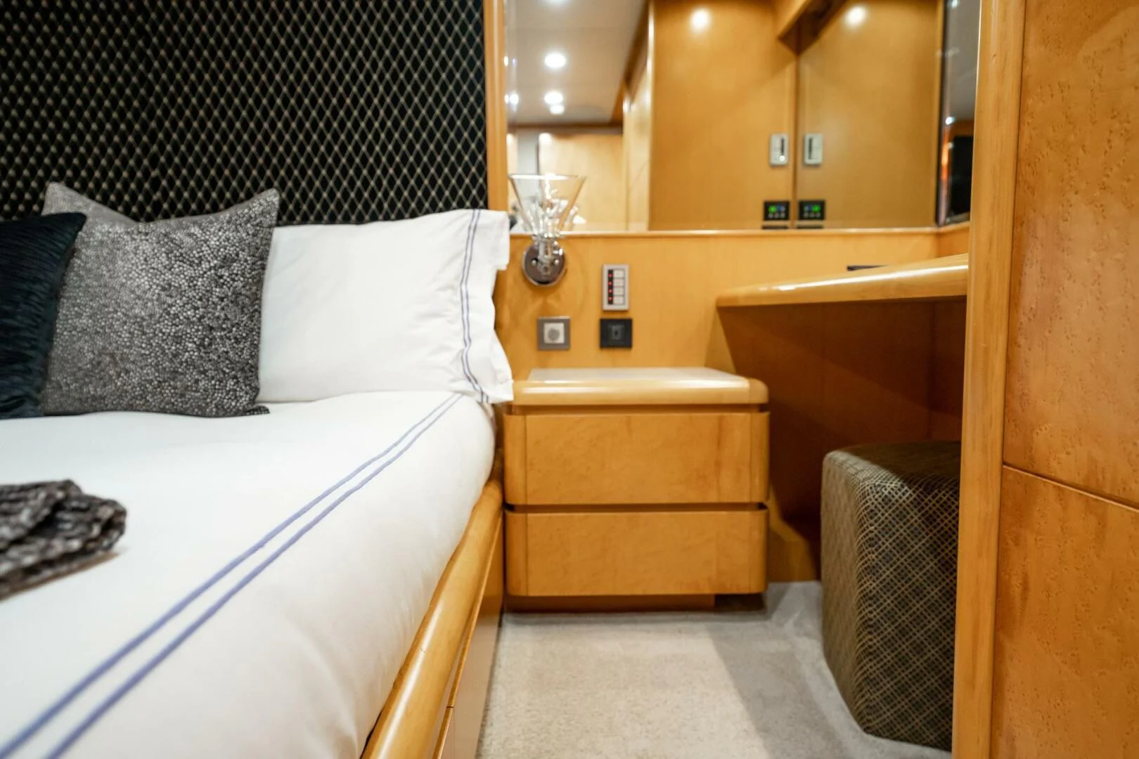 a bed with a white bed spread aboard ISLAND HEIRESS Yacht for Charter