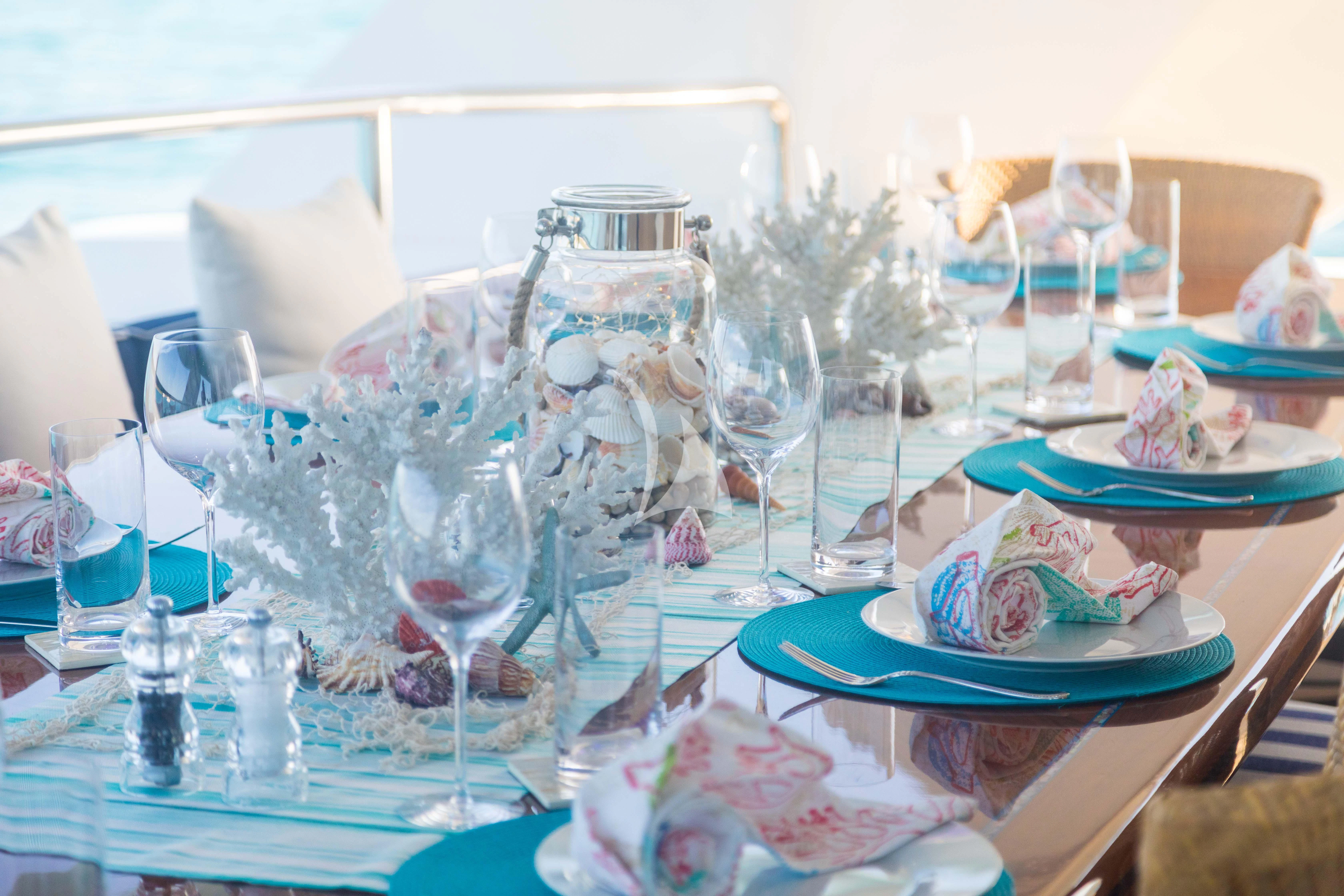 a table set with glasses and plates aboard ISLAND HEIRESS Yacht for Charter