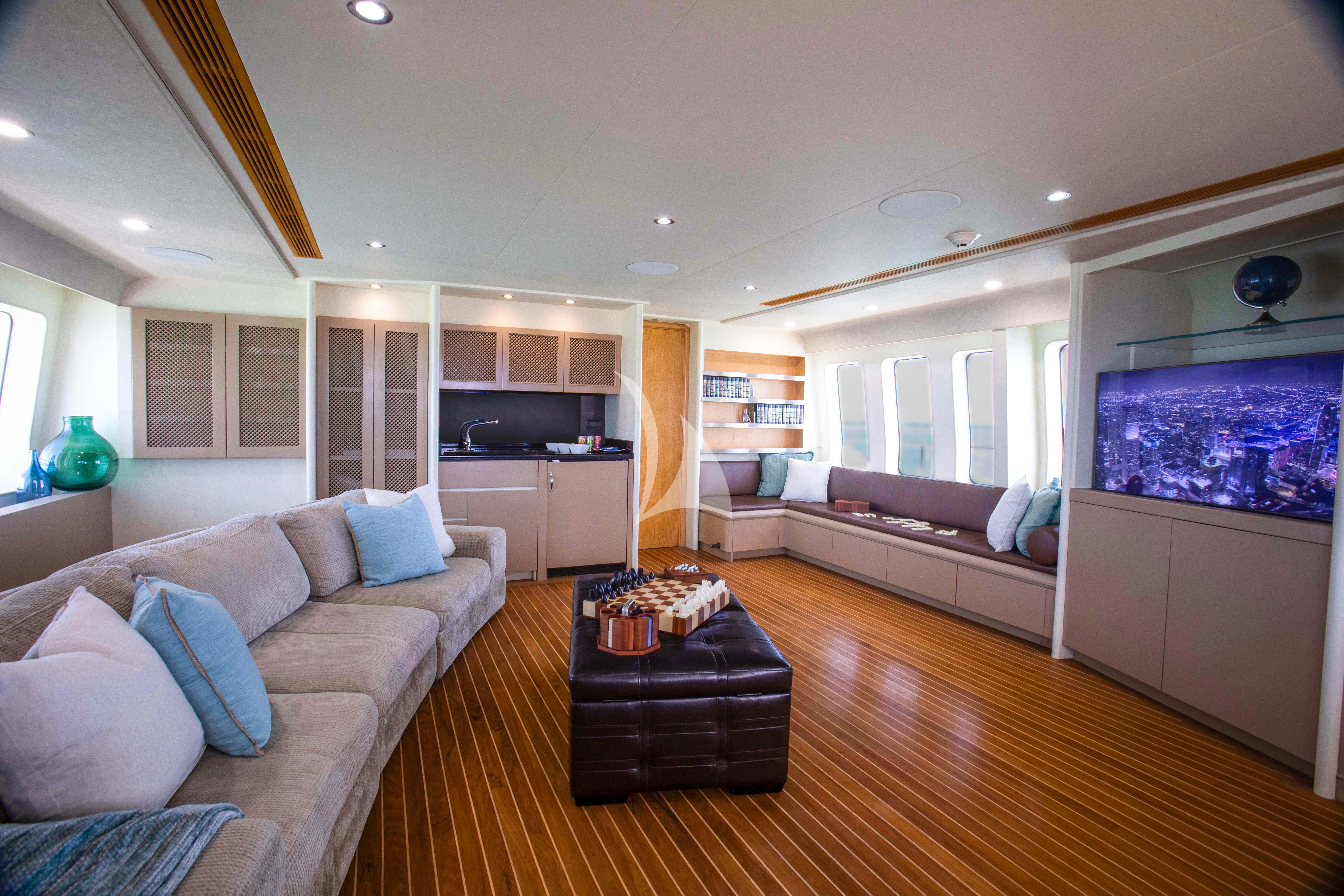 a living room with a couch and a tv aboard ISLAND HEIRESS Yacht for Charter