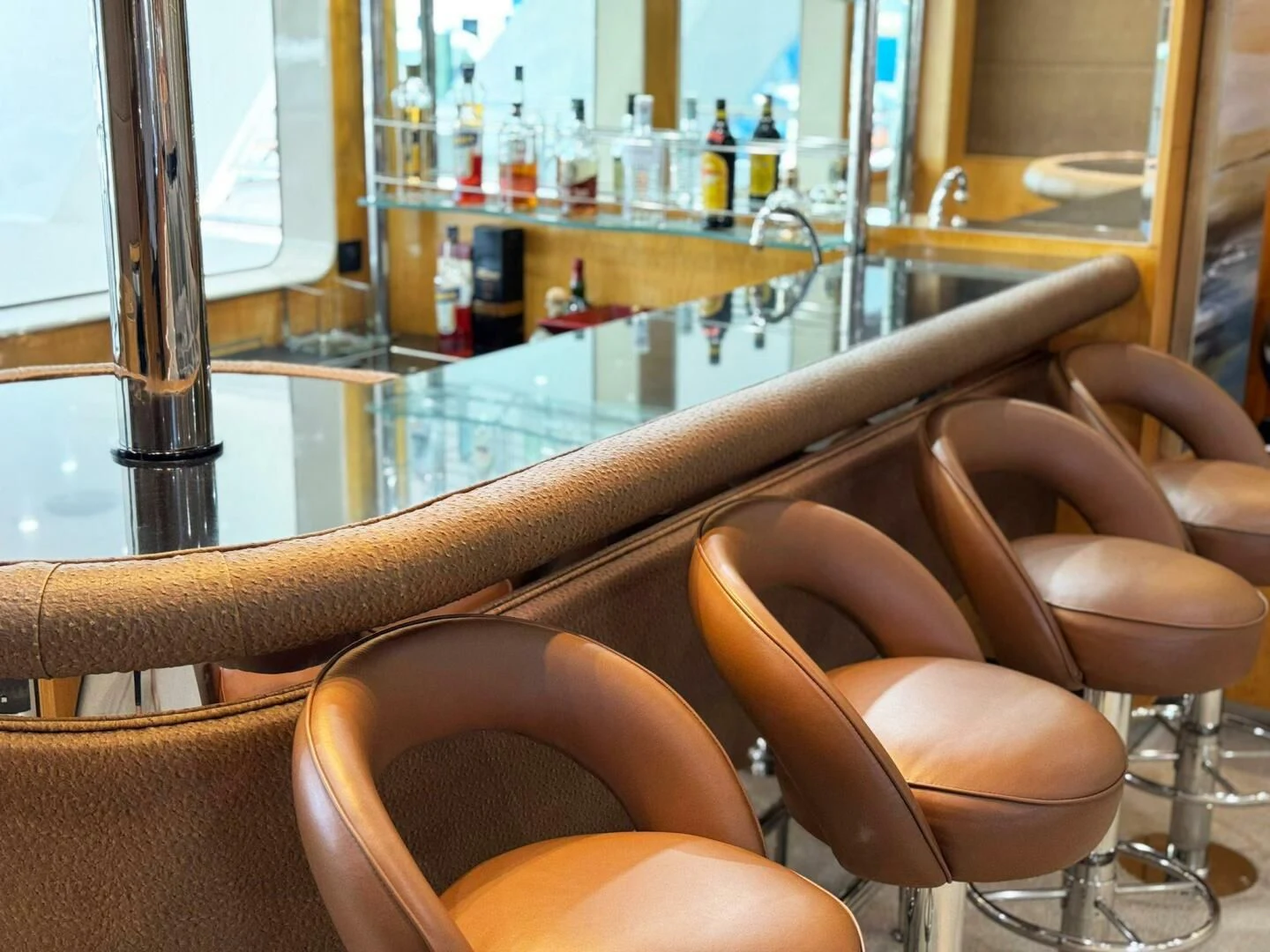 a brown leather boot on a glass table in a bar aboard ISLAND HEIRESS Yacht for Charter