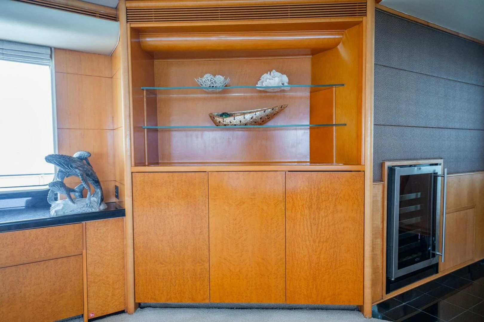 a room with a cabinet and a shelf with a bird on it aboard ISLAND HEIRESS Yacht for Charter
