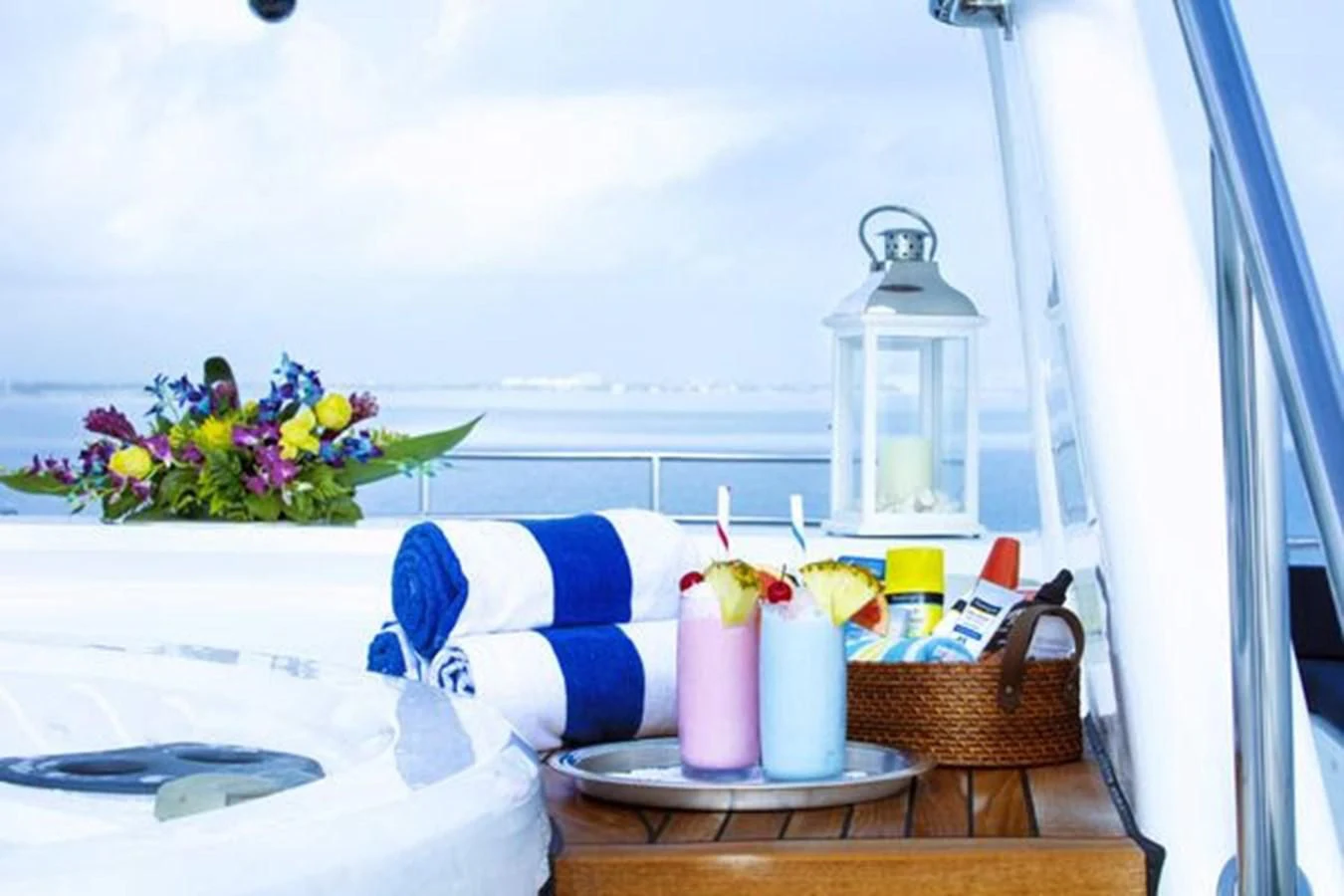 a table with a basket of flowers and candles on it aboard ISLAND HEIRESS Yacht for Charter