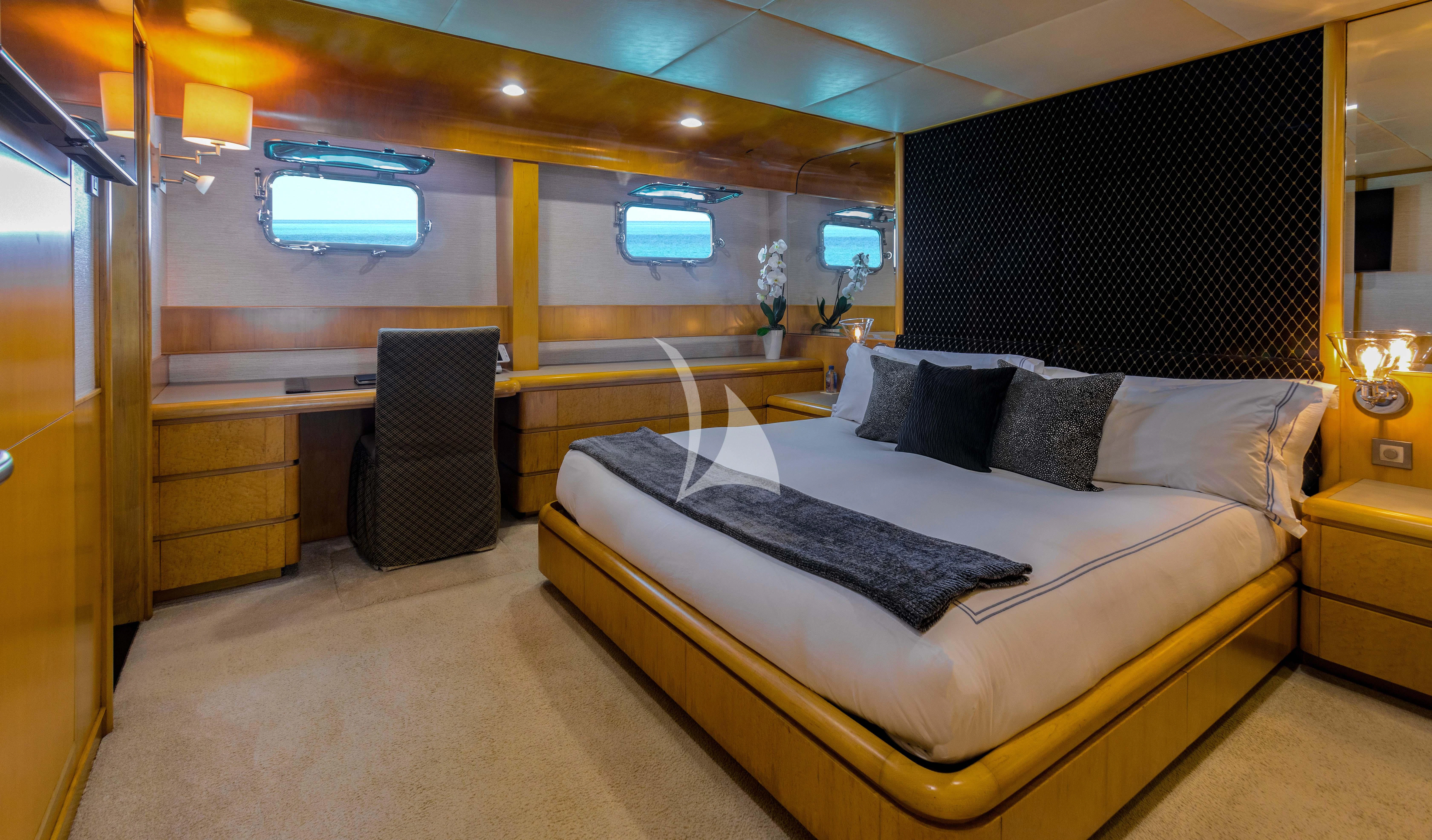 a room with a bed and a chair aboard ISLAND HEIRESS Yacht for Charter