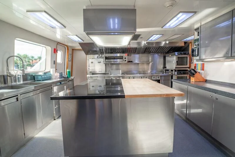 a kitchen with a large island aboard ISLAND HEIRESS Yacht for Charter