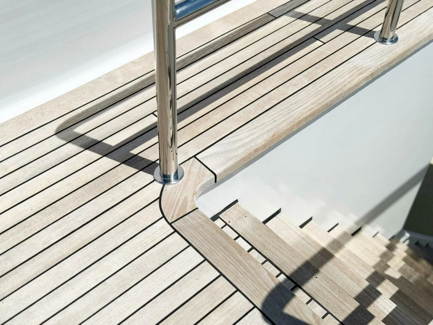 a wooden walkway with a railing aboard ISLAND HEIRESS Yacht for Charter