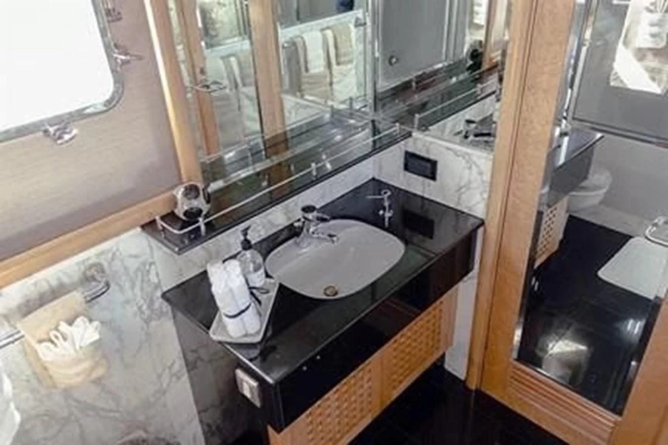 a bathroom with a sink and mirror aboard ISLAND HEIRESS Yacht for Charter