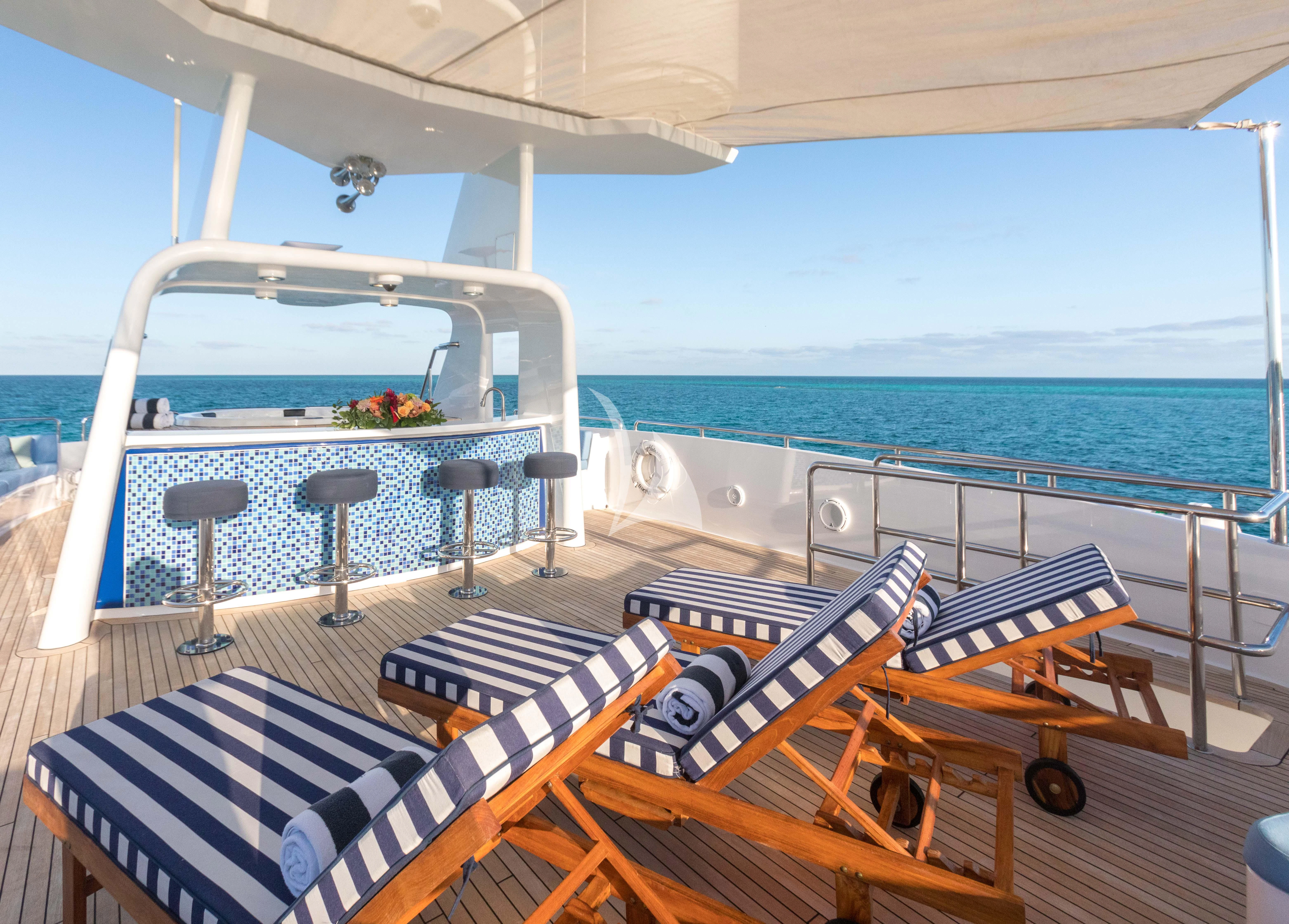 a deck with chairs and tables on it aboard ISLAND HEIRESS Yacht for Charter