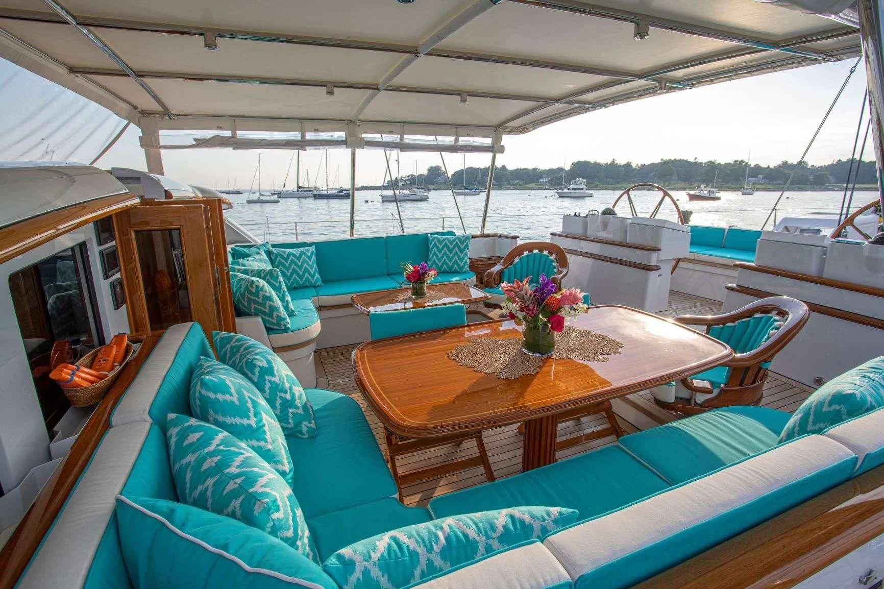 a boat with a table and chairs aboard WHISPER Yacht for Sale