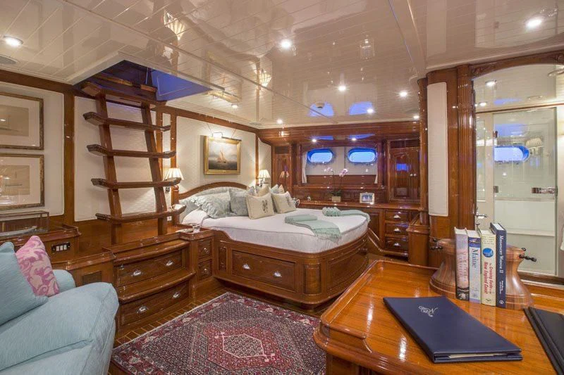 a bedroom with a bed and a desk aboard WHISPER Yacht for Sale