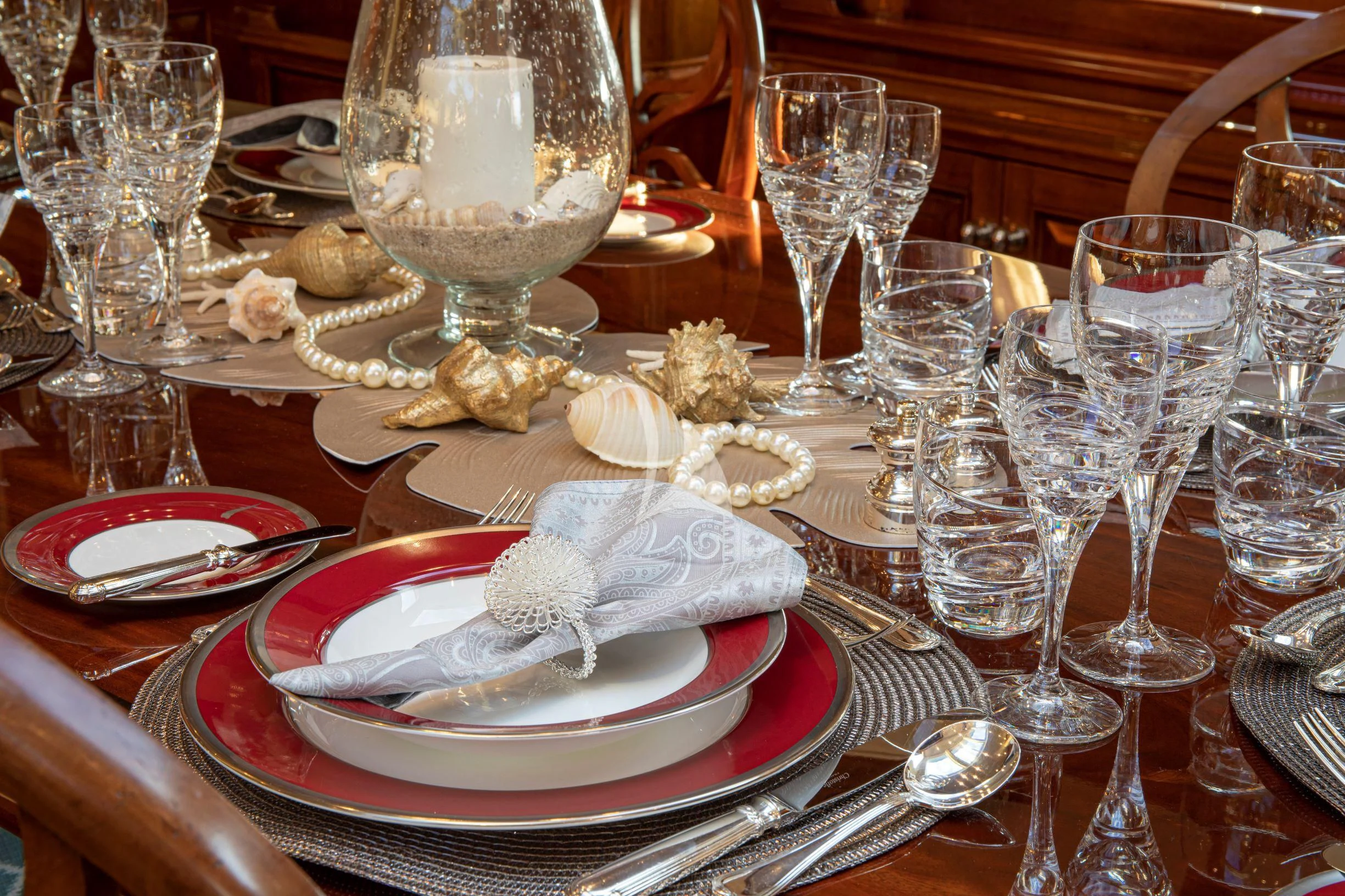 a table with wine glasses and food on it aboard WHISPER Yacht for Sale