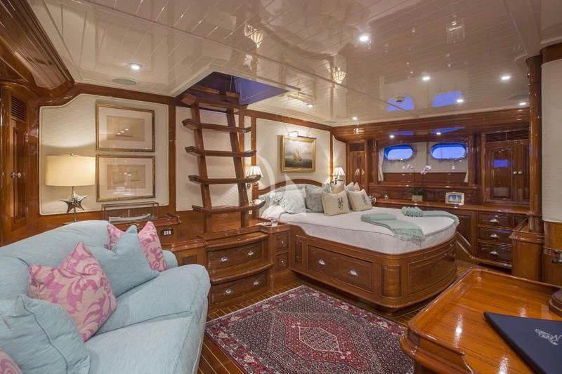 a bedroom with a bed and a bookcase aboard WHISPER Yacht for Sale