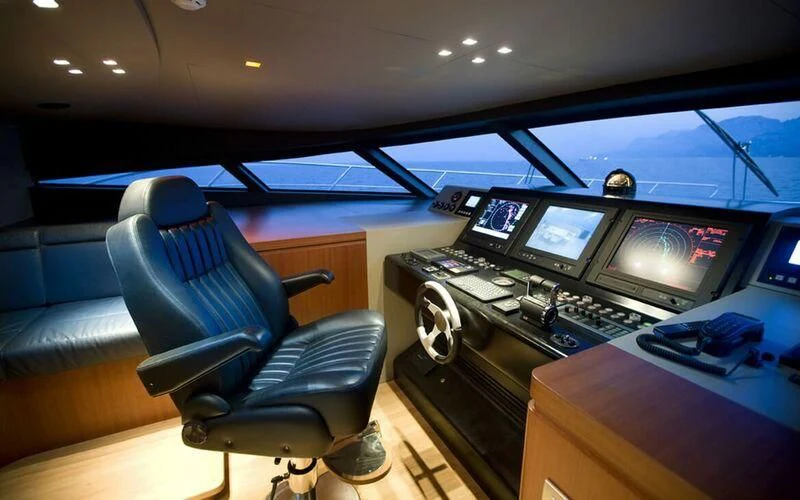 a control room with a chair and computers aboard NEW VOGUE Yacht for Sale