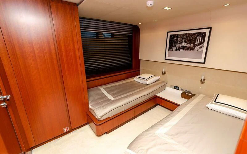 a room with a bed and a desk aboard NEW VOGUE Yacht for Sale