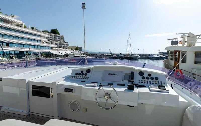 a white boat in a harbor aboard NEW VOGUE Yacht for Sale