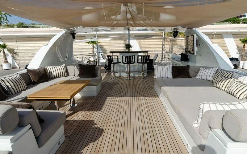 a room with couches and tables aboard NEW VOGUE Yacht for Sale