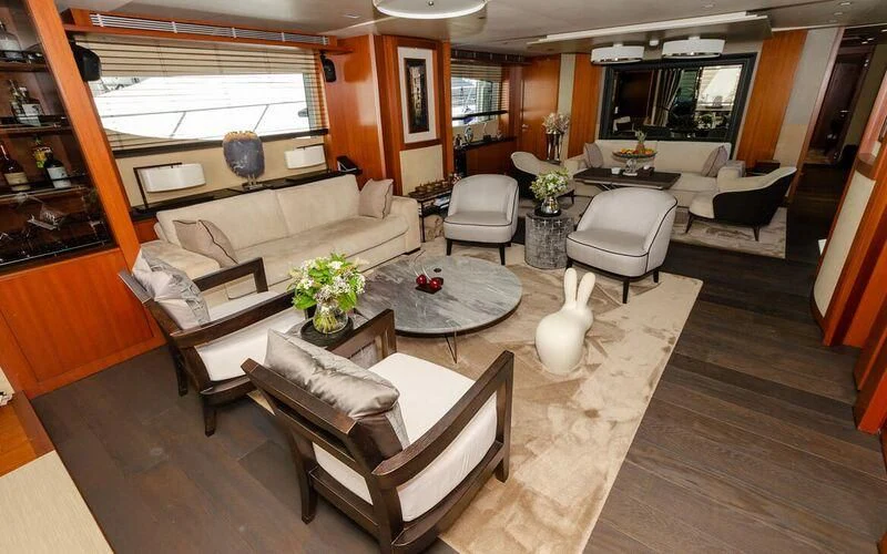 a living room with a couch and a coffee table aboard NEW VOGUE Yacht for Sale
