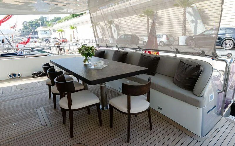 a table and chairs in a room aboard NEW VOGUE Yacht for Sale