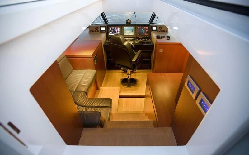 a room with a couch and a tv aboard NEW VOGUE Yacht for Sale