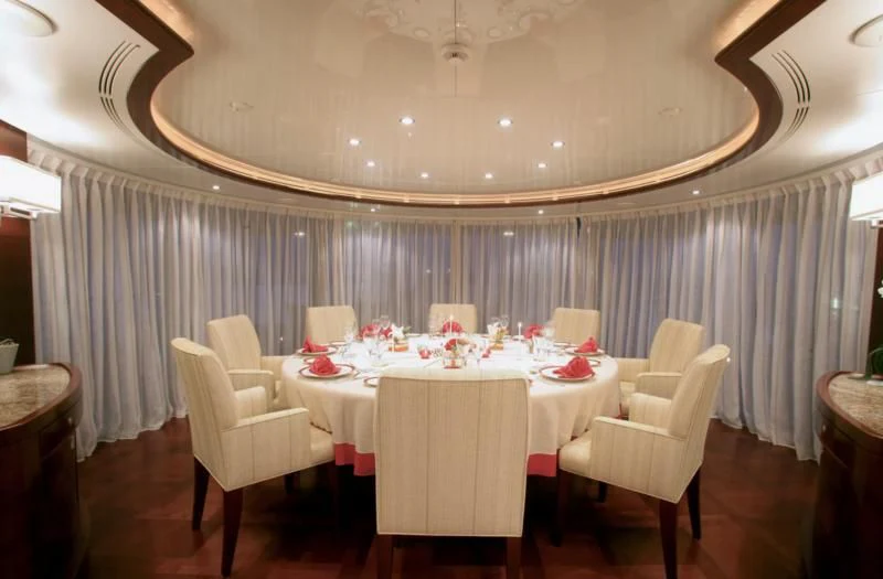 a room with a table and chairs aboard SEASCAPE V Yacht for Sale