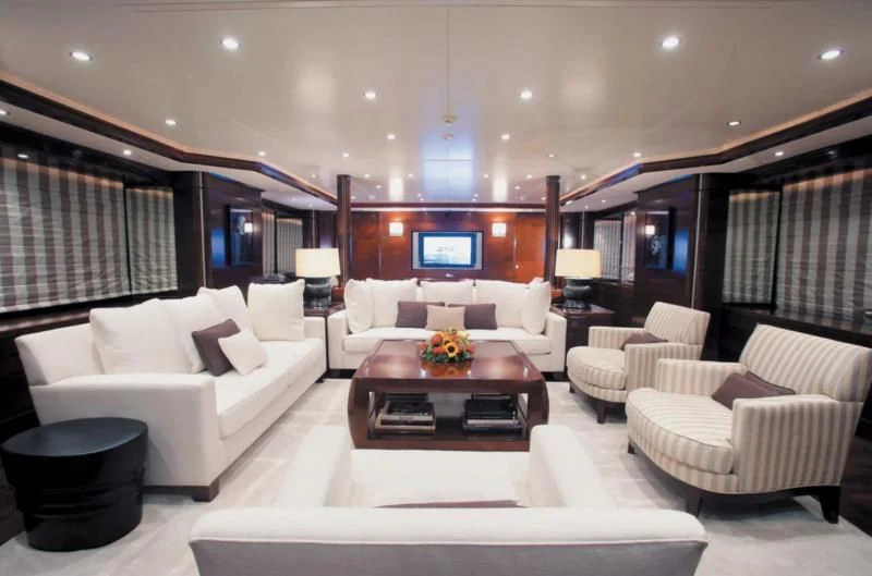 a living room with white furniture aboard SEASCAPE V Yacht for Sale