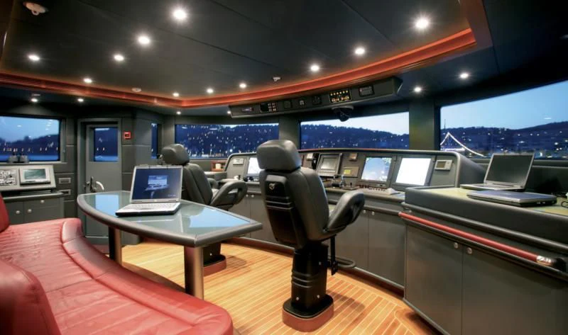 a room with a desk and a laptop on a table aboard SEASCAPE V Yacht for Sale