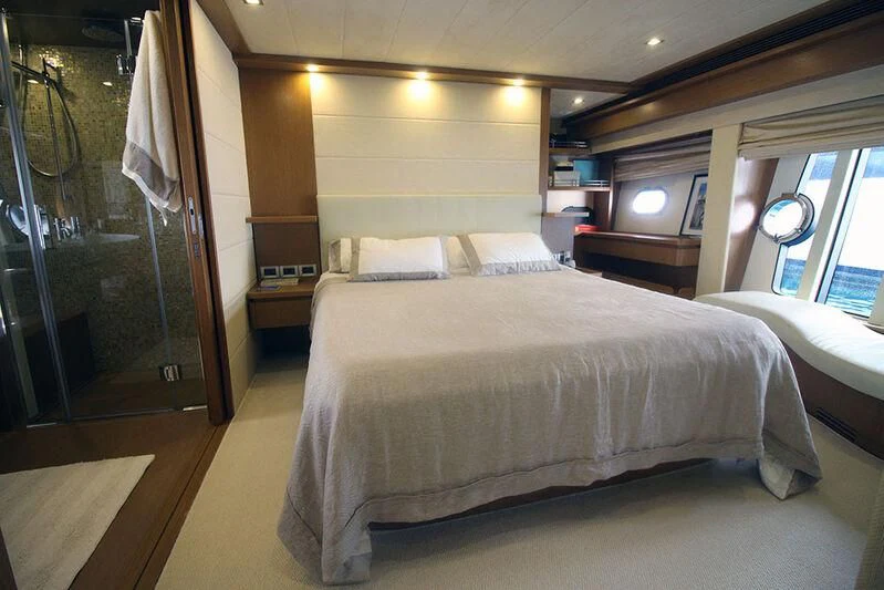 a bedroom with a bed and a tv aboard ARGO Yacht for Sale