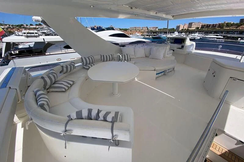 a room with white beds and white chairs aboard ARGO Yacht for Sale