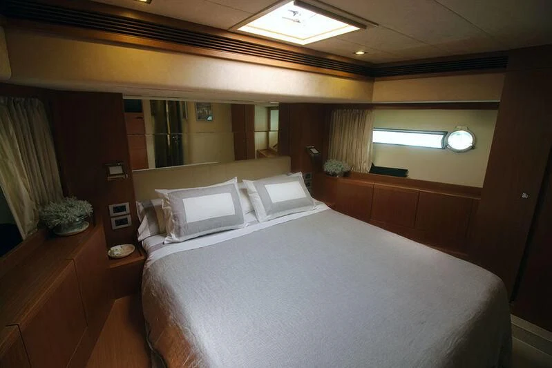 a bed with white sheets aboard ARGO Yacht for Sale