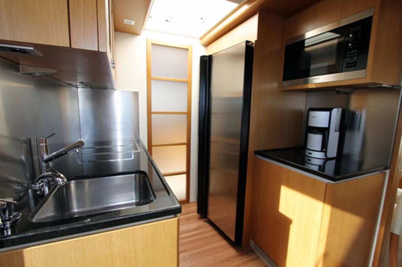 a kitchen with a microwave oven aboard ARGO Yacht for Sale