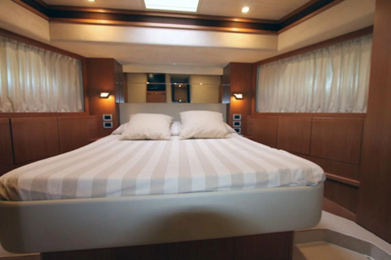a bed with white sheets aboard ARGO Yacht for Sale