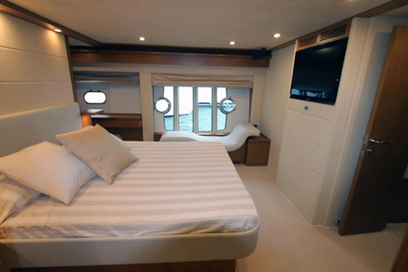 a room with a bed and a television aboard ARGO Yacht for Sale
