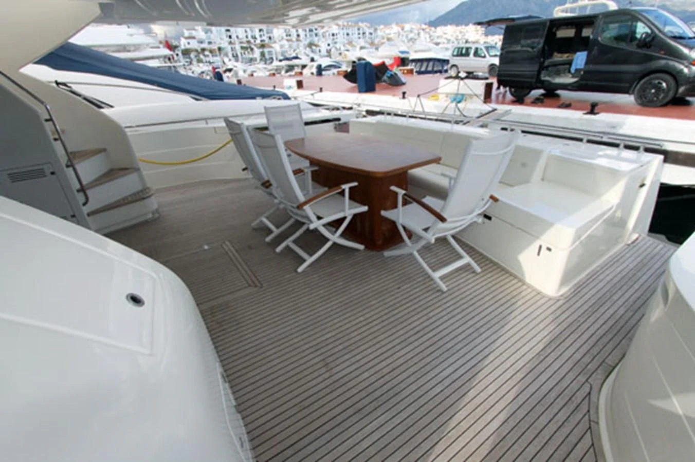 a deck with a table and chairs aboard ARGO Yacht for Sale