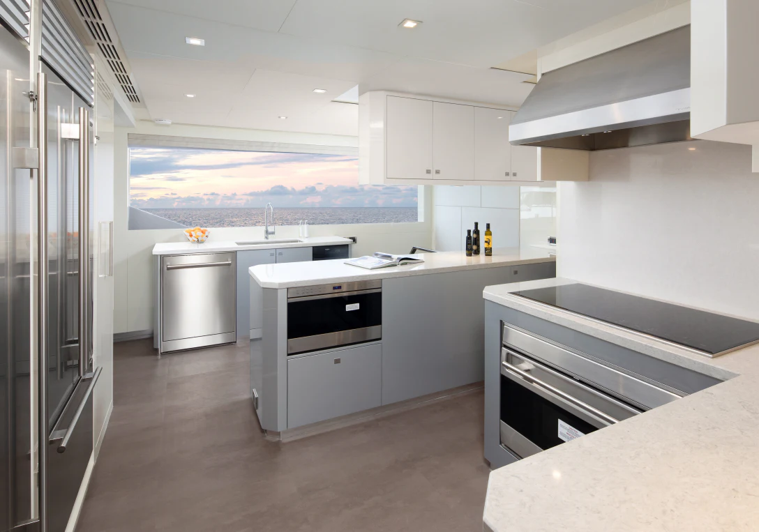 a kitchen with white cabinets aboard MÖBIUS Yacht for Sale