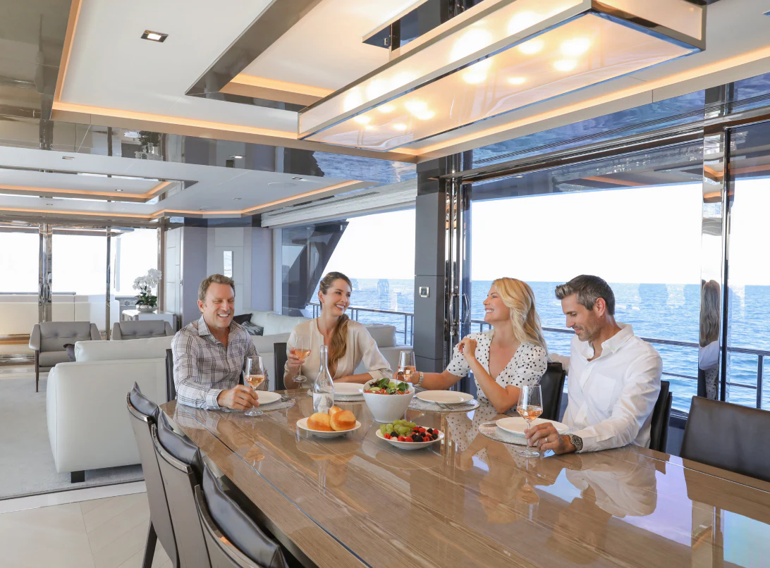 a group of people sitting around a table aboard MÖBIUS Yacht for Sale