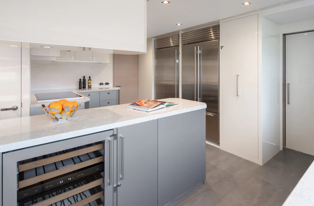 a kitchen with white cabinets aboard MÖBIUS Yacht for Sale