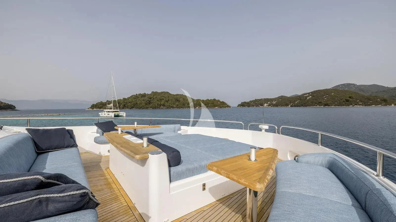 a deck with a view of the ocean and boats on it aboard EXIT Yacht for Sale