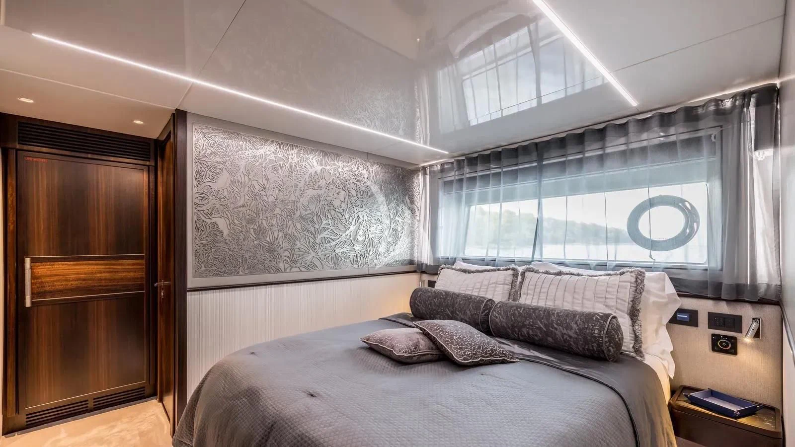 a bedroom with a bed and a wood door aboard EXIT Yacht for Sale