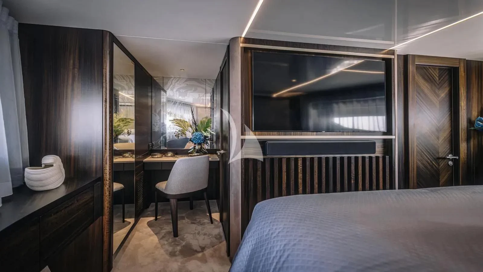 a bedroom with a bed and a desk aboard EXIT Yacht for Sale