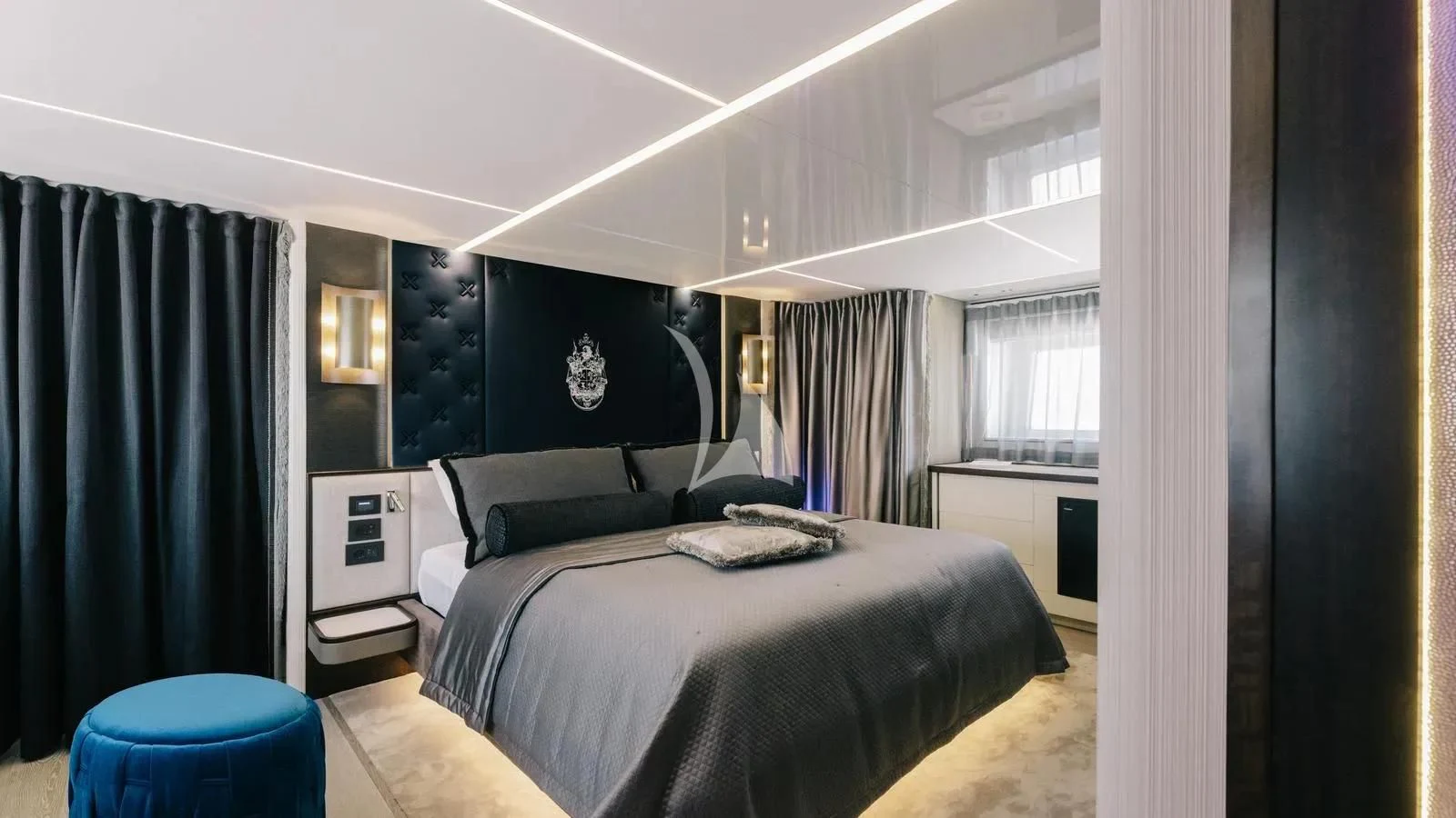 a bedroom with a bed and a desk aboard EXIT Yacht for Sale