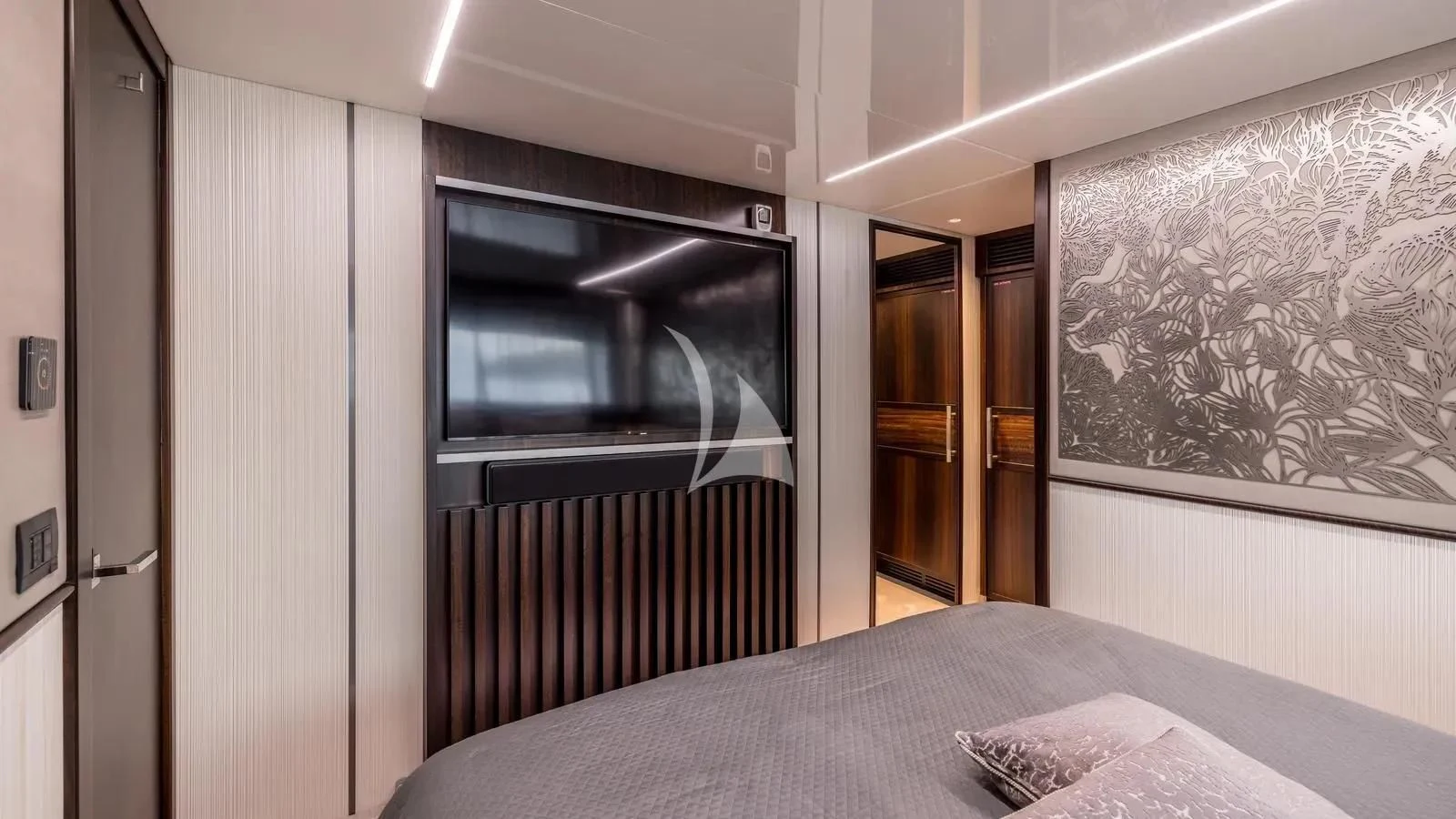 a bedroom with a bed and a tv aboard EXIT Yacht for Sale
