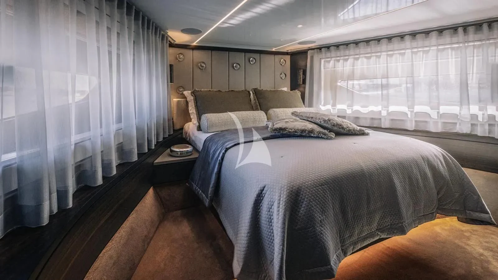 a bedroom with a bed and a window aboard EXIT Yacht for Sale