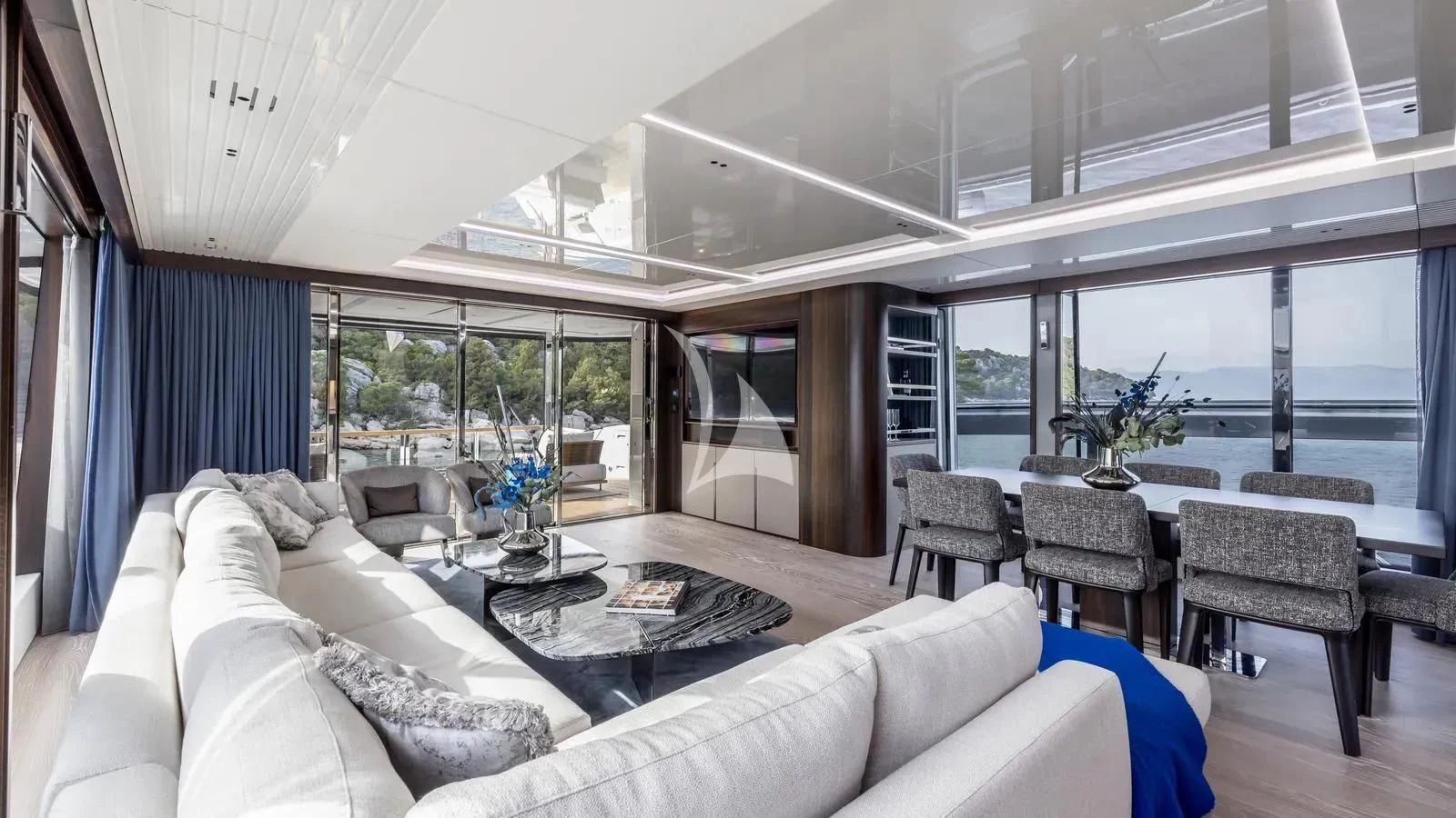a living room with a large glass window aboard EXIT Yacht for Sale