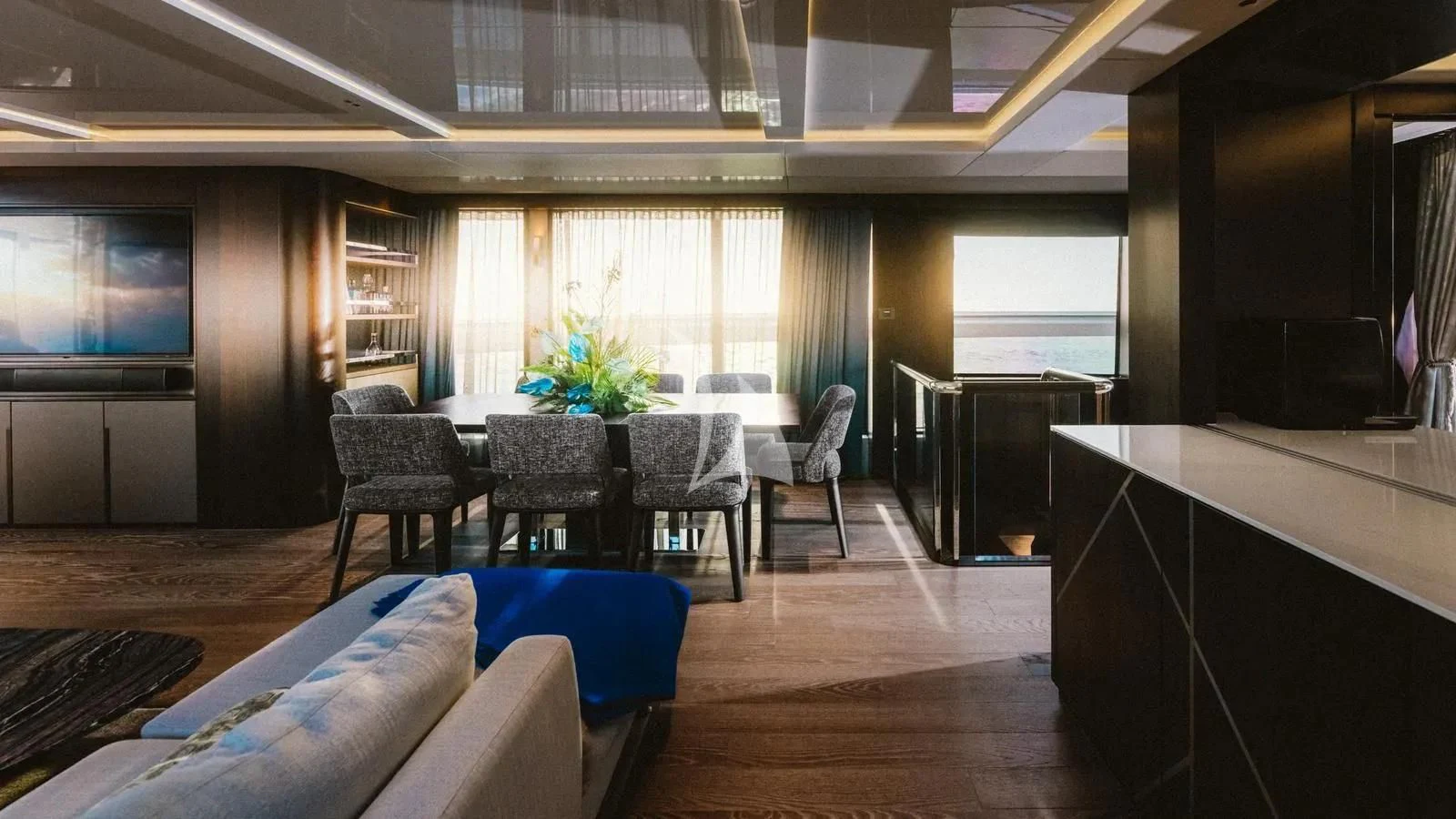 a room with a table chairs and a tv aboard EXIT Yacht for Sale