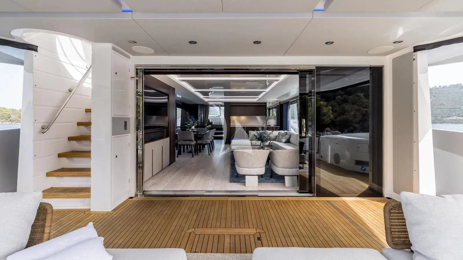 a room with a wood floor and a staircase aboard EXIT Yacht for Sale