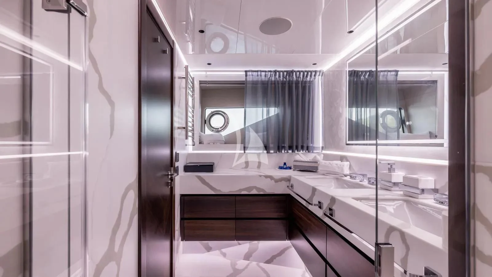 a bathroom with a tub sink and cabinets aboard EXIT Yacht for Sale