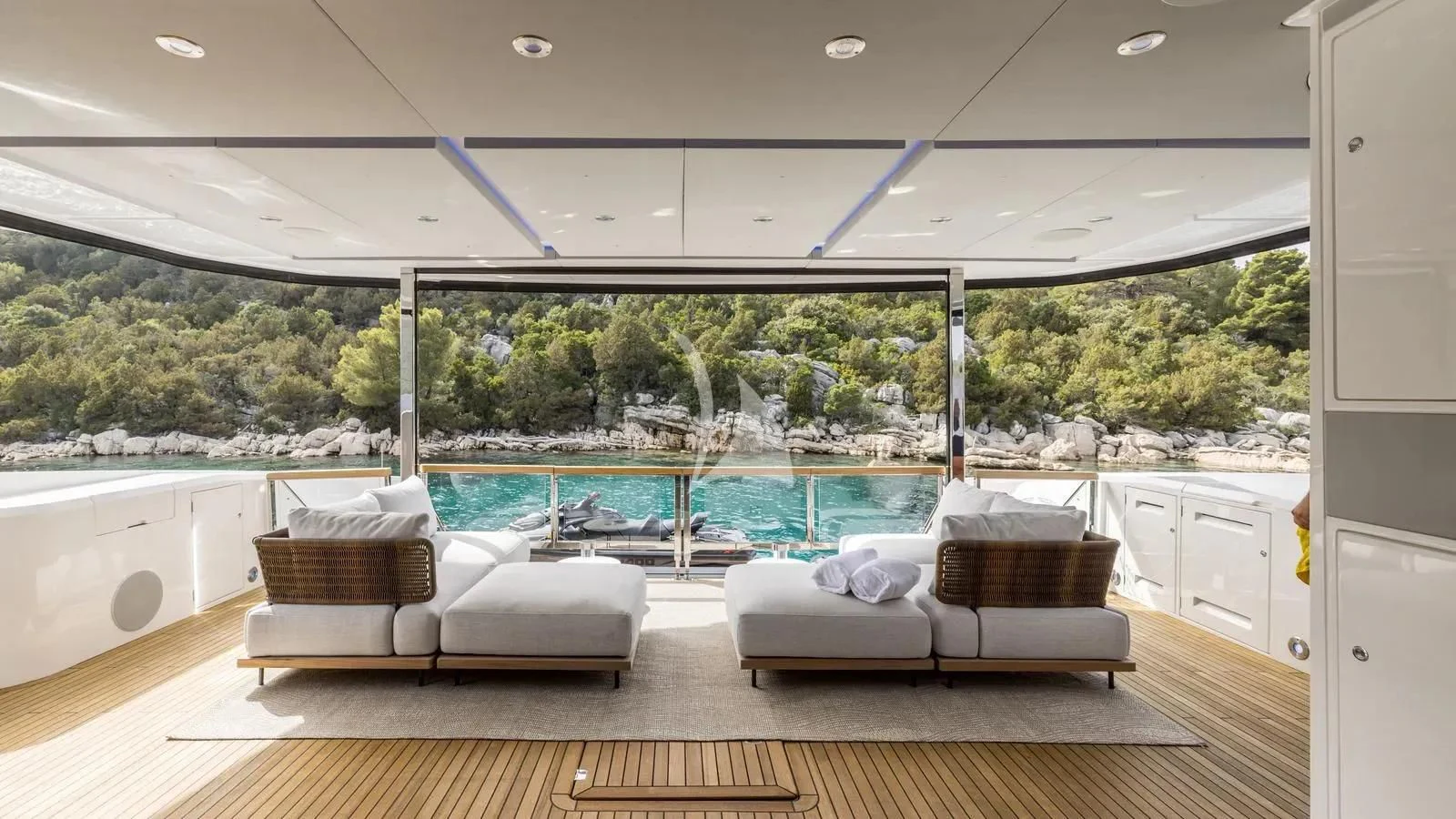 a room with a pool and a deck with couches aboard EXIT Yacht for Sale